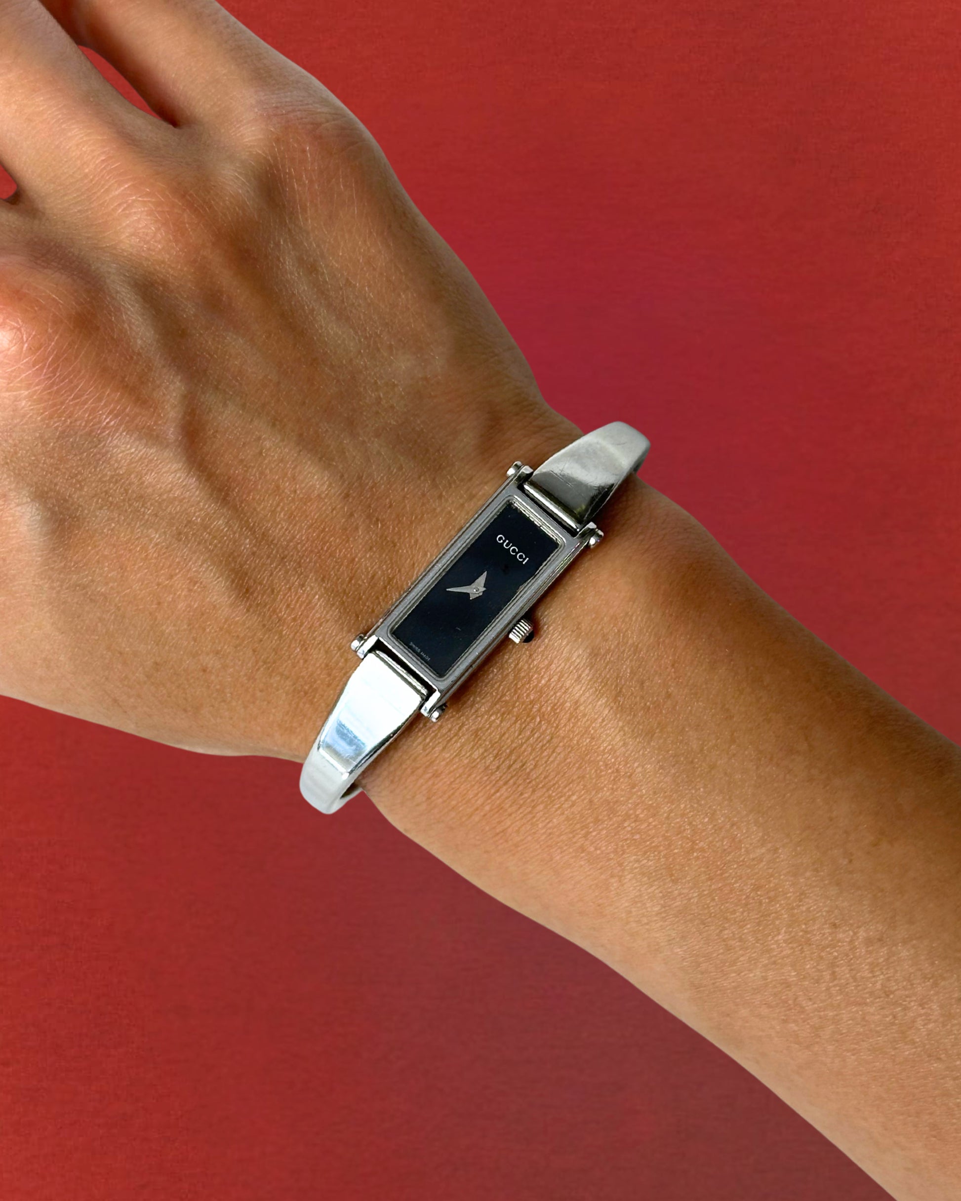 1990s Gucci silver tone black dial bangle watch