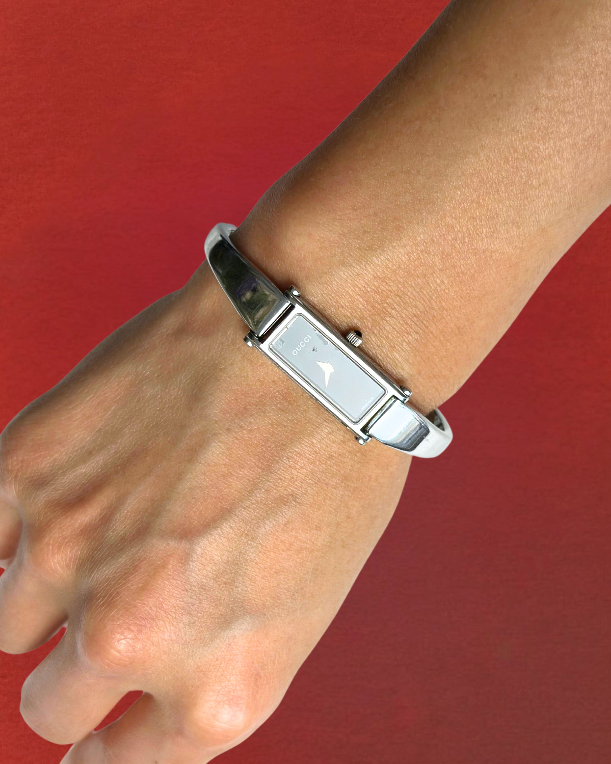 1990s Gucci silver tone black dial bangle watch