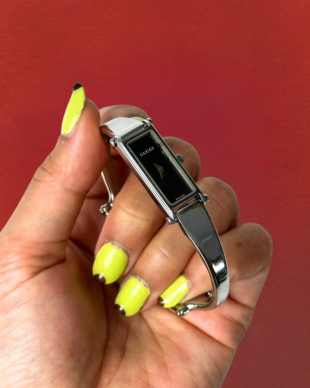 1990s Gucci silver tone black dial bangle watch