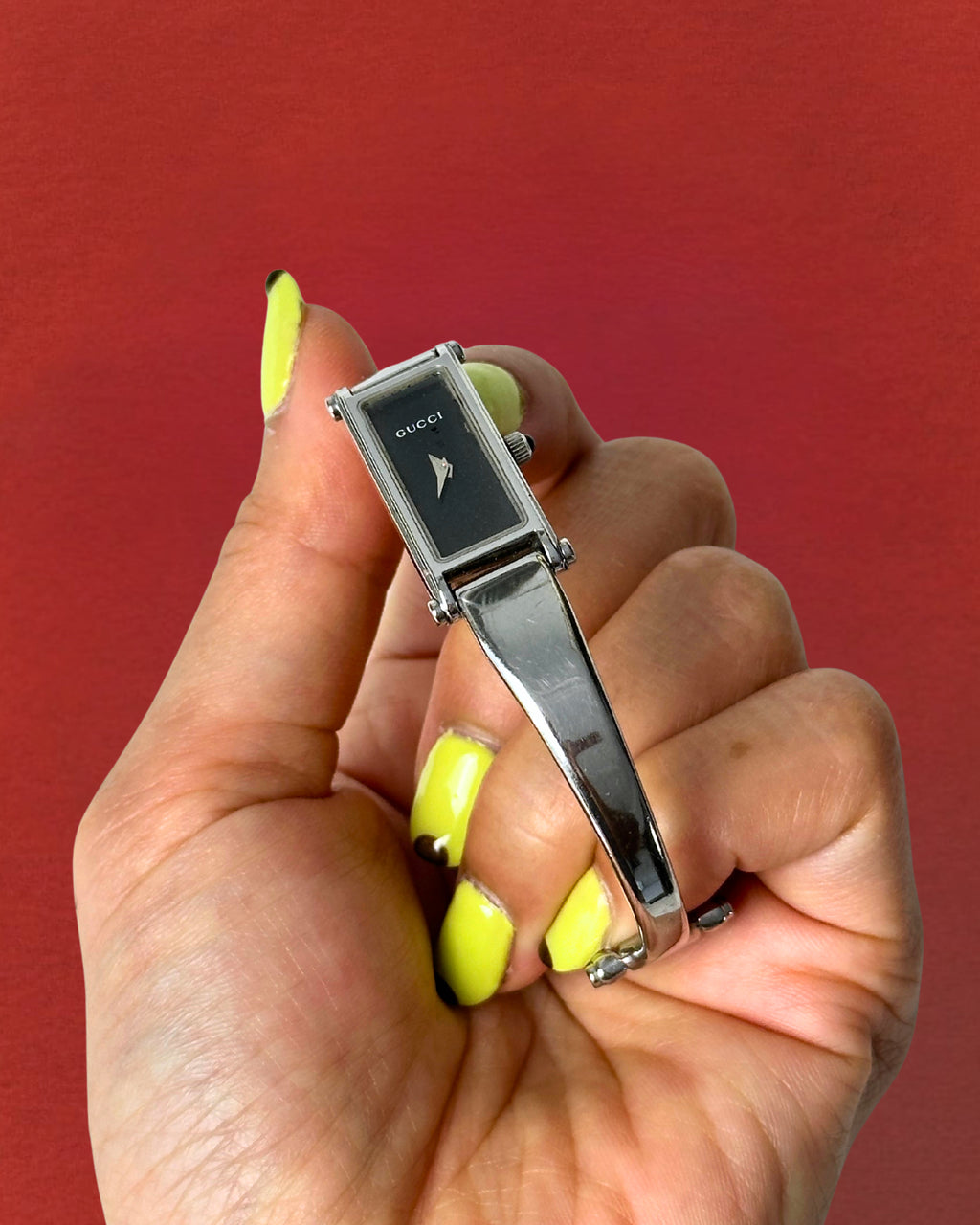 1990s Gucci silver tone black dial bangle watch