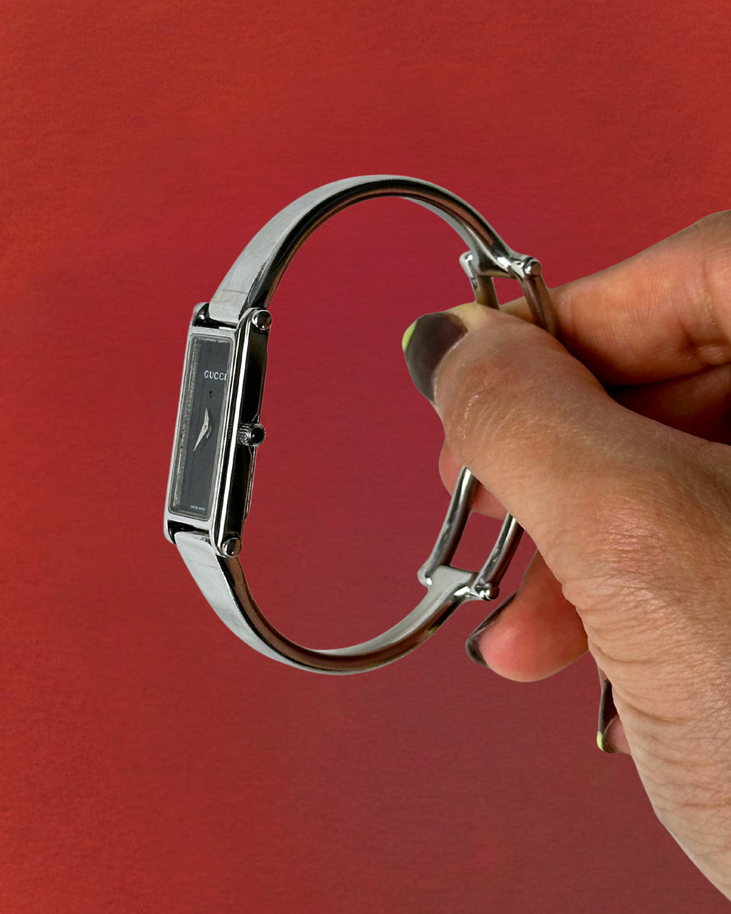 1990s Gucci silver tone black dial bangle watch