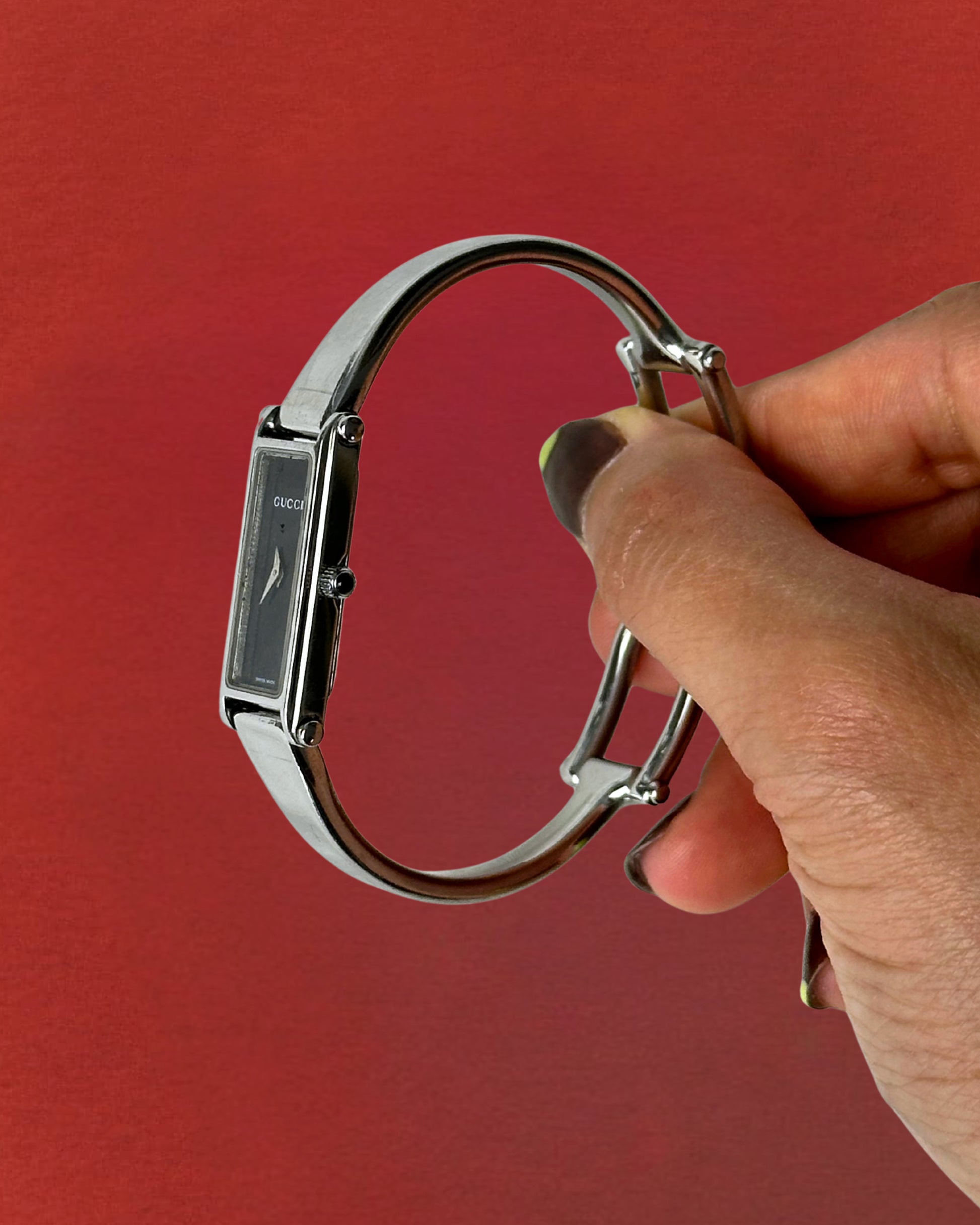 1990s Gucci silver tone black dial bangle watch
