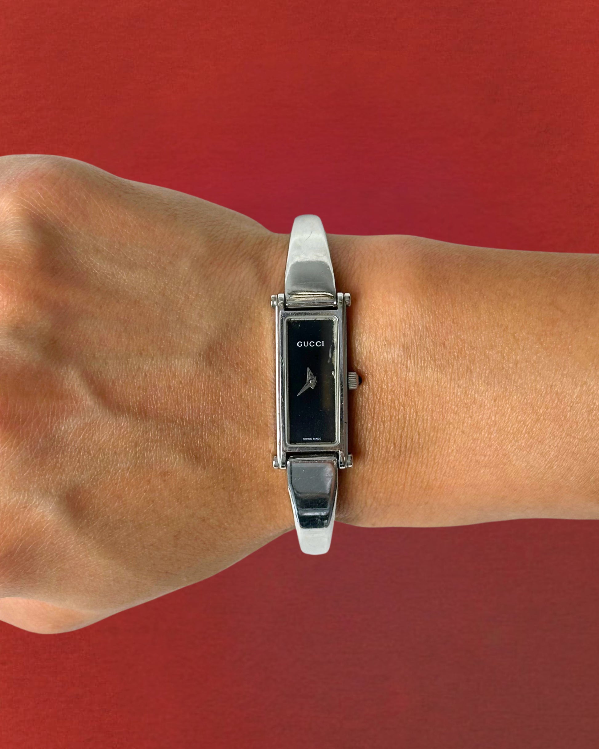 1990s Gucci silver tone black dial bangle watch